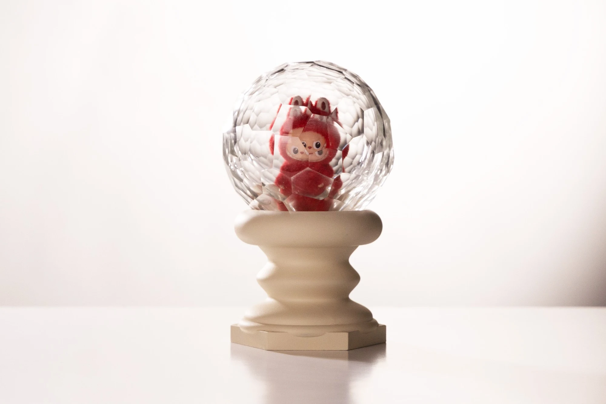 The same piece from the front, the figure's face split and repeated by the facets