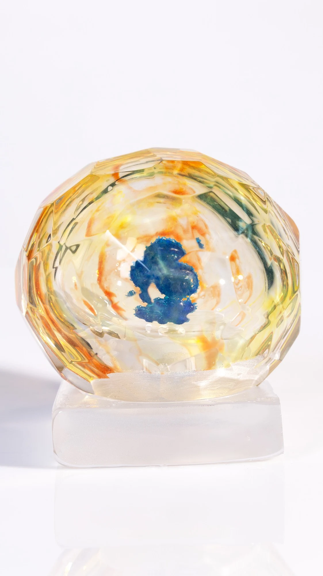 The same piece from another side, the blue form seen whole through a central facet