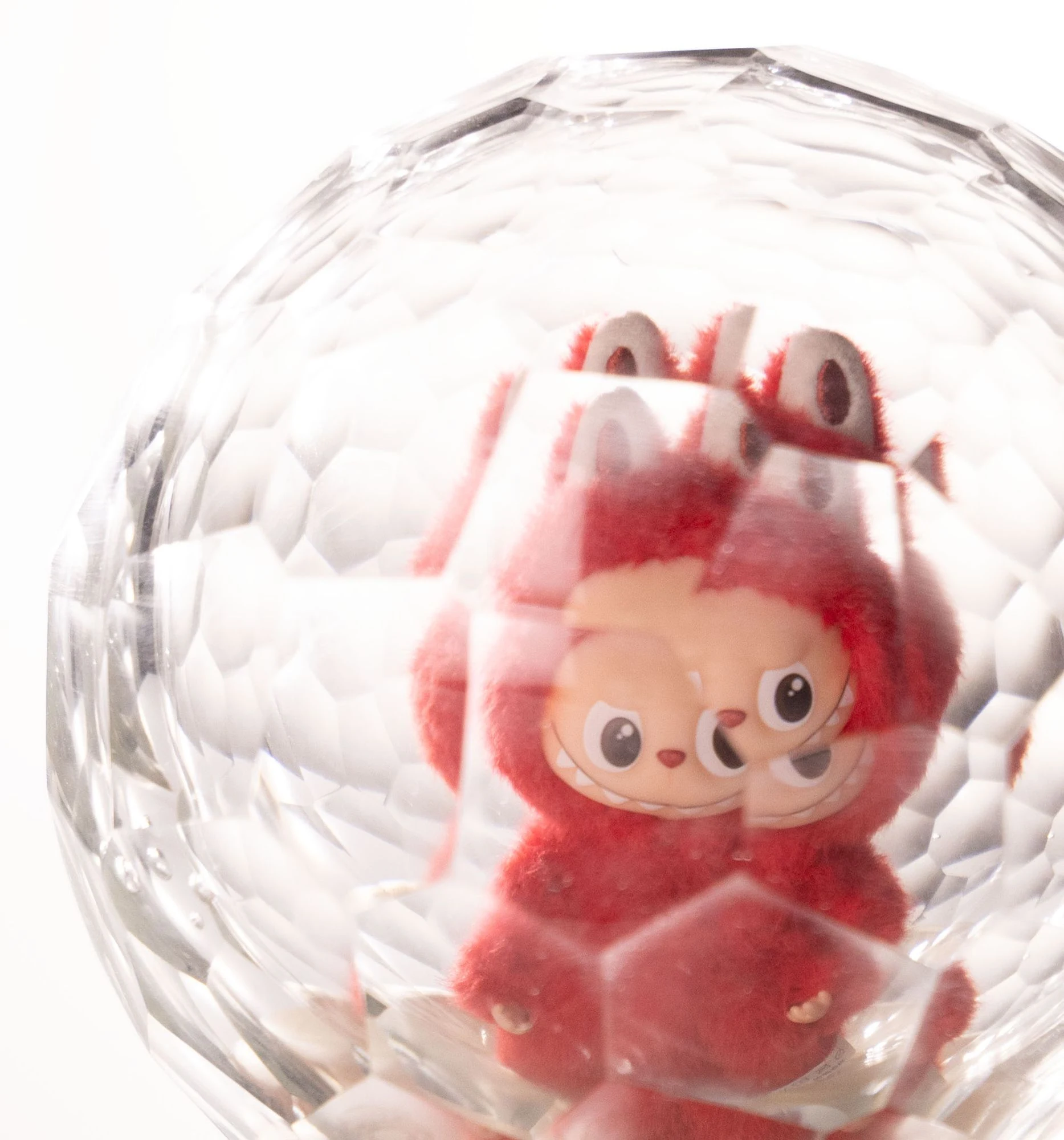 Close view through the facets: the figure's eyes and ears multiplied