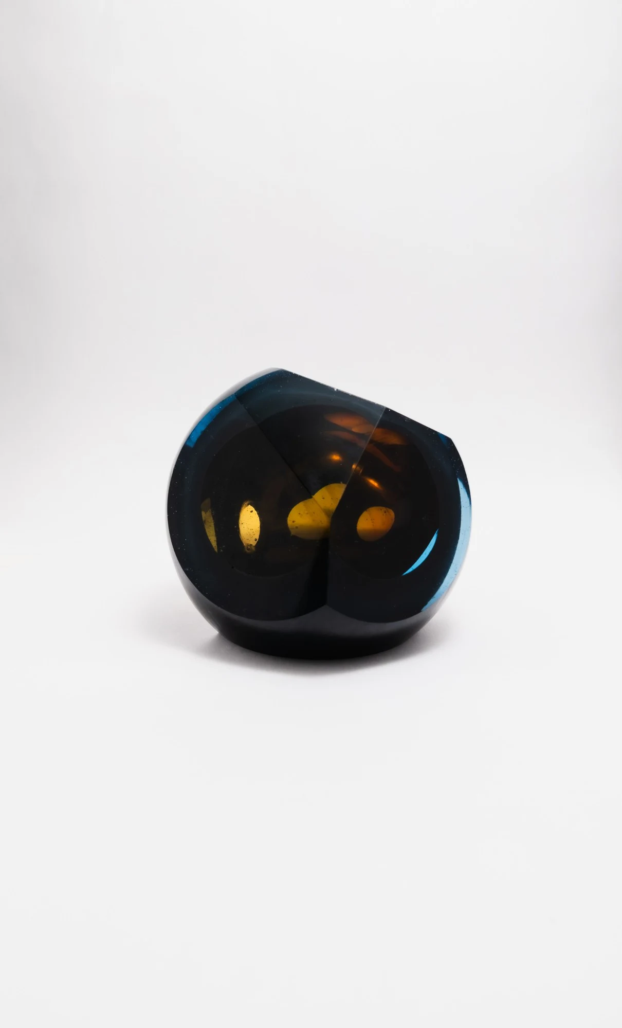 Two curved cuts meeting, the amber shapes repeated in each