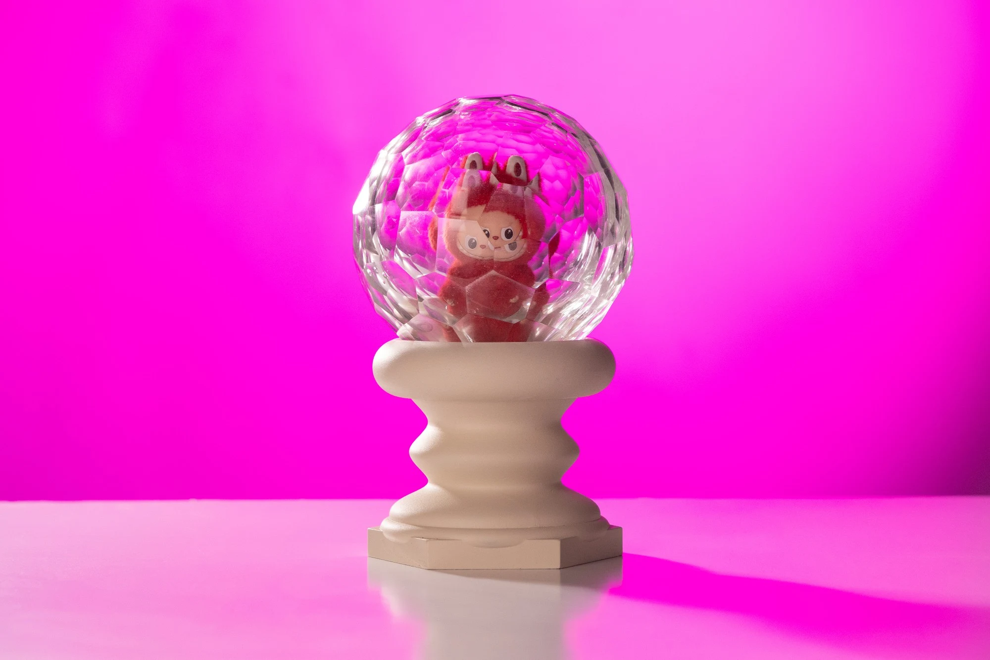 The piece against a magenta background